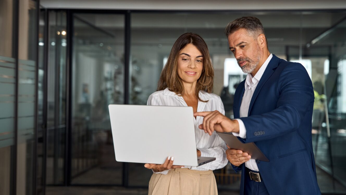 Man and woman discussing project on laptop